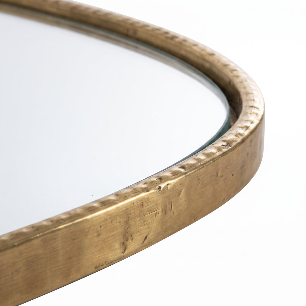 Close-up of the hand-etched texture on the brass mirror frame