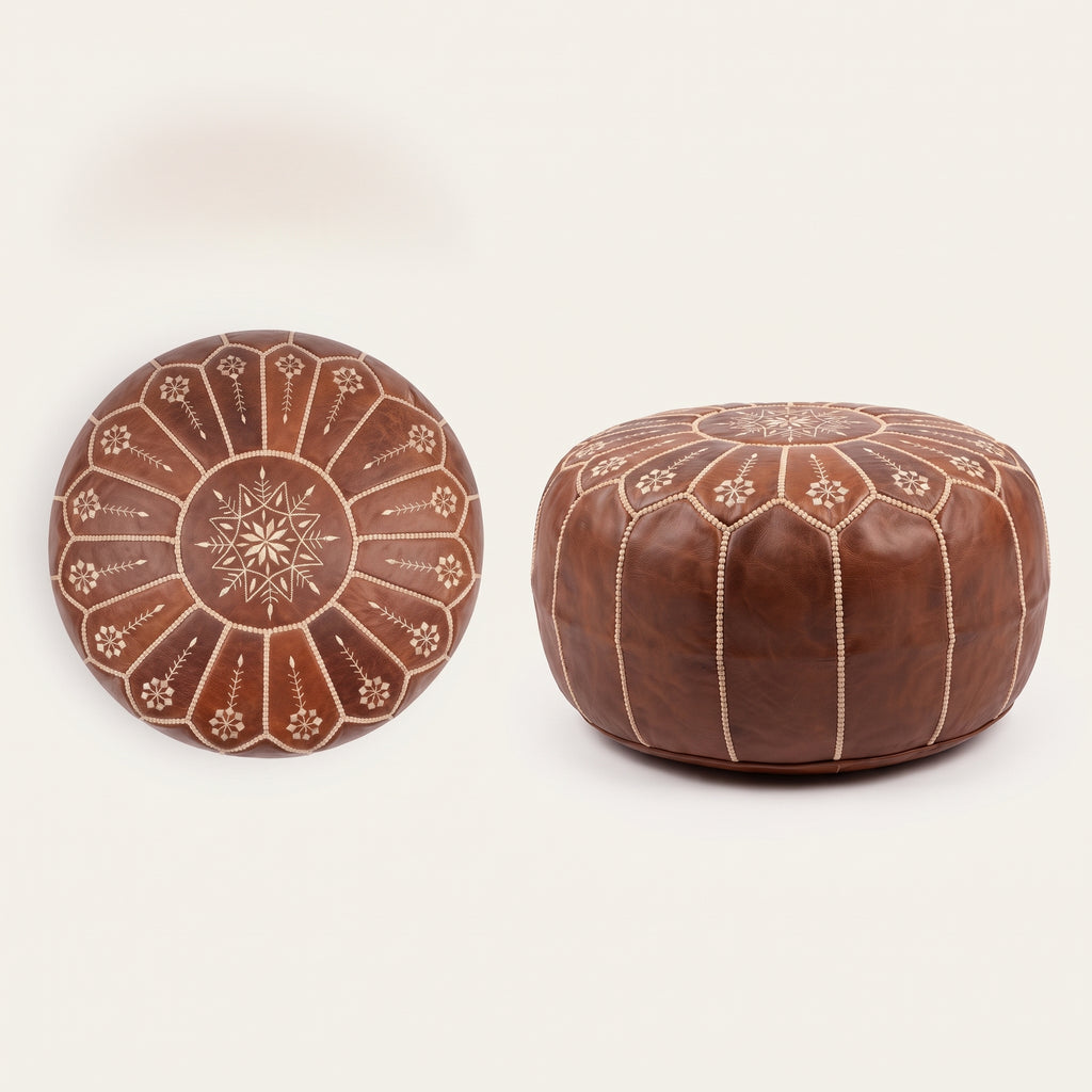 Top and side views of a brown leather pouf with white floral embroidery