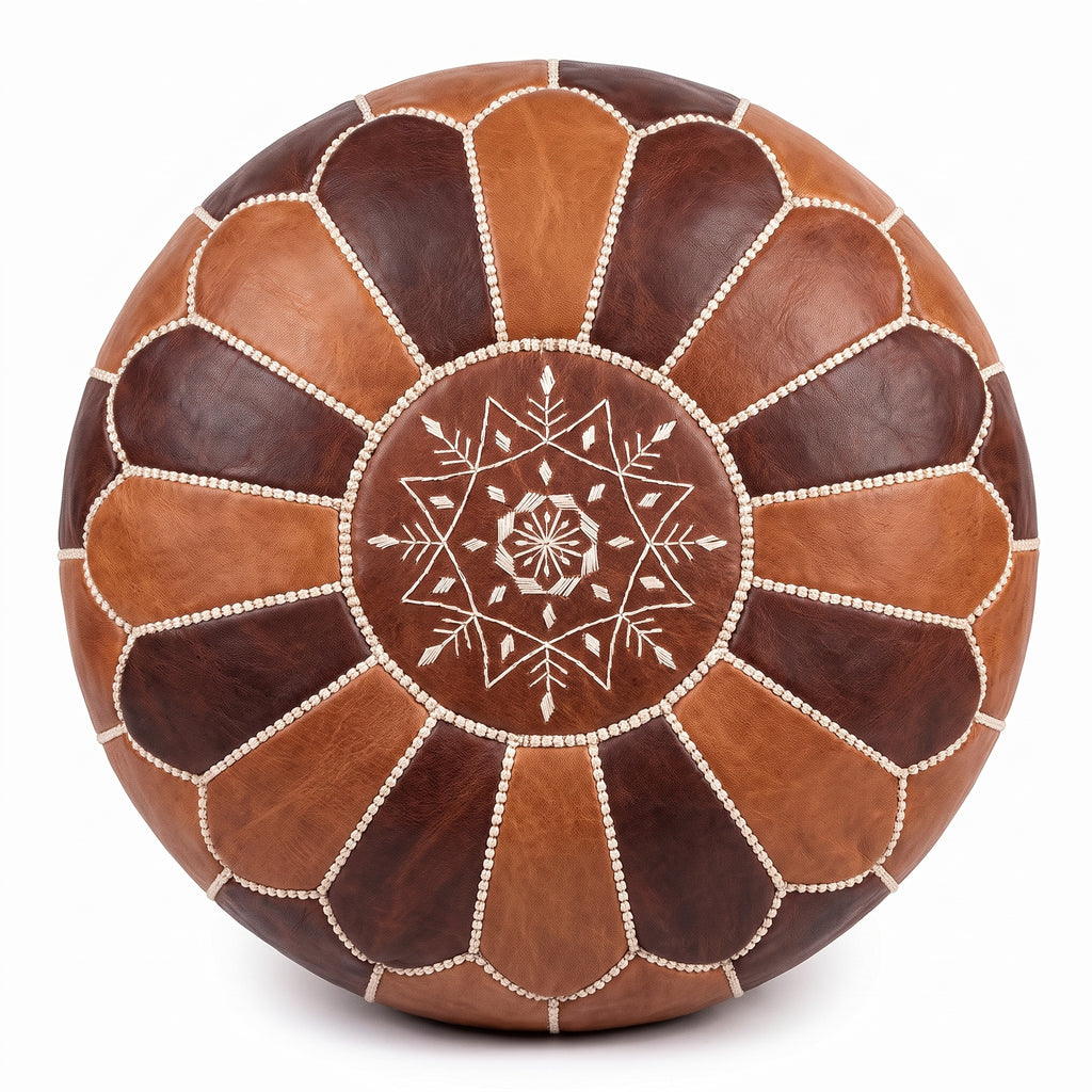 Overhead view of a two-tone brown Moroccan leather pouf with a stitched star medallion