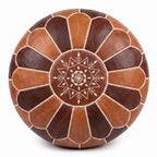 Overhead view of a two-tone brown Moroccan leather pouf with a stitched star medallion