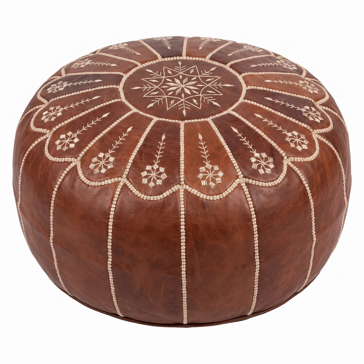 Angled view of a brown leather pouf showing its embroidered floral top