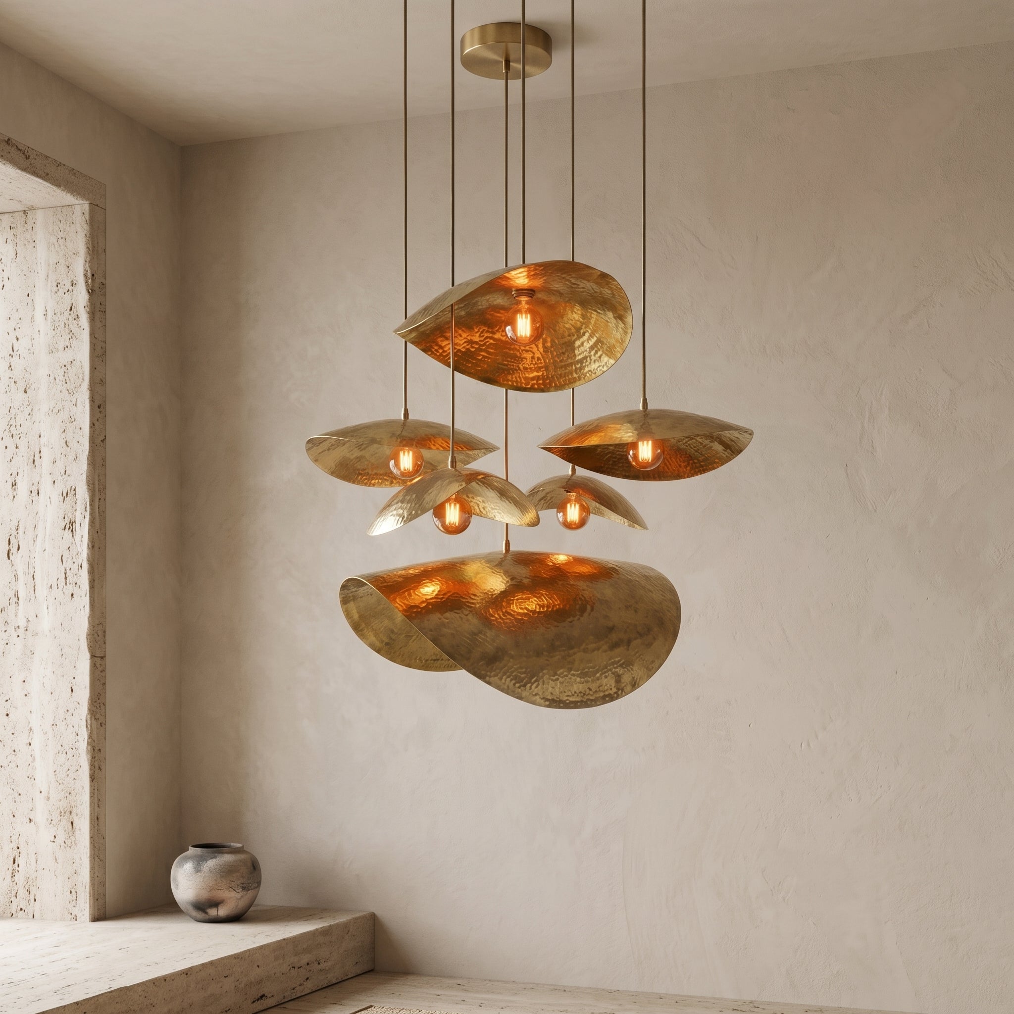 Brass multi-light chandelier installed in a neutral interior