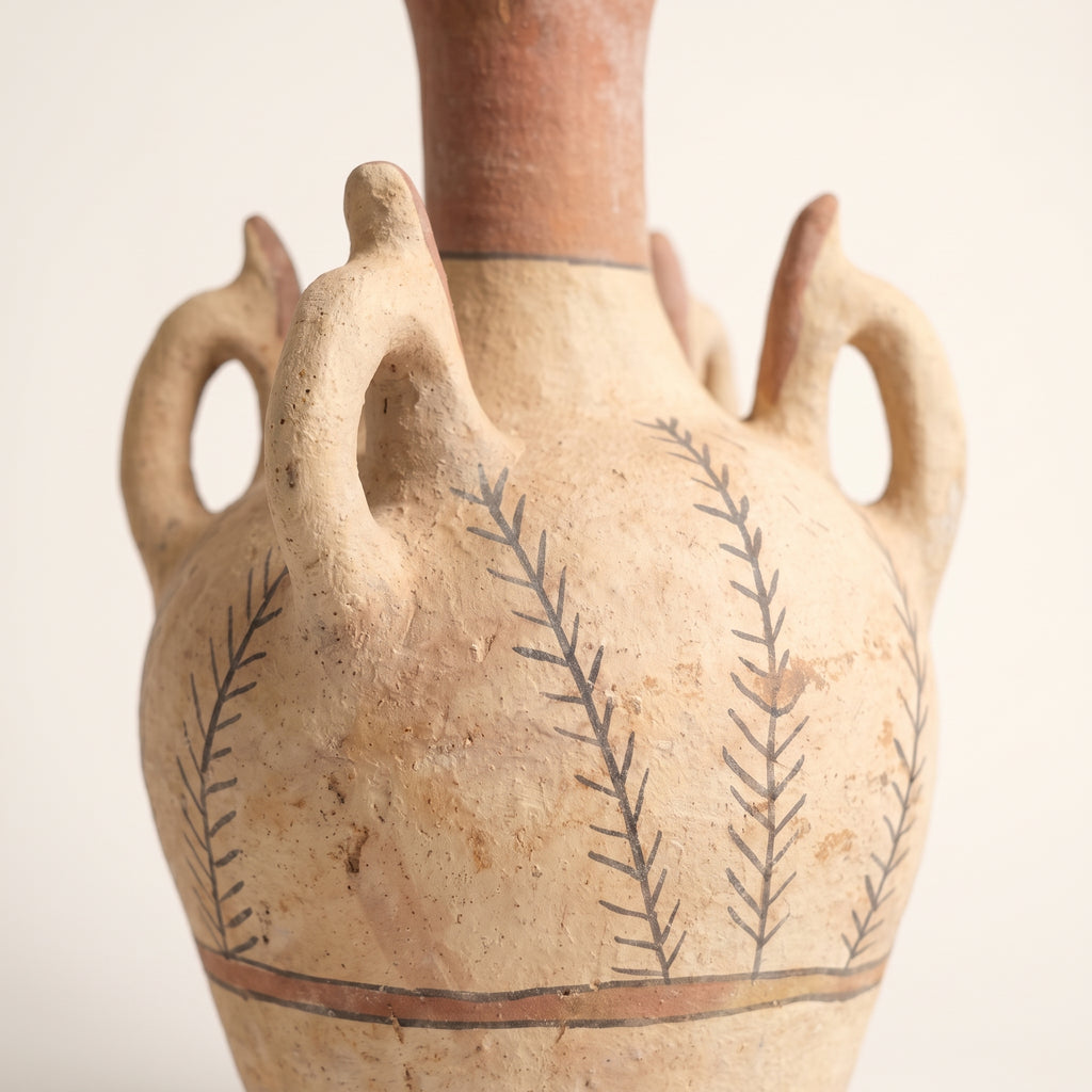Detailed view of the textured ceramic surface and hand-drawn leaf motifs