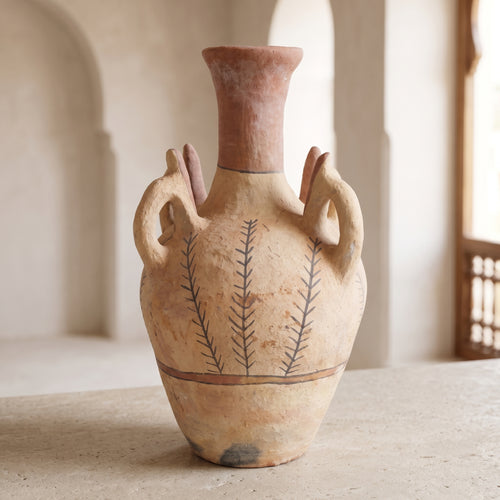 Handmade ceramic vase with natural finish displayed in a neutral interior
