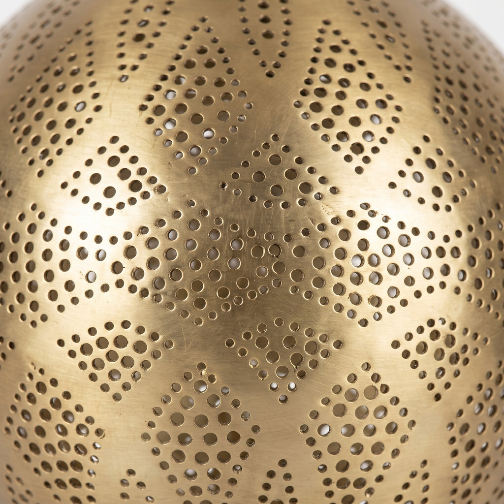 Close-up of the geometric perforations in the brass lamp shade