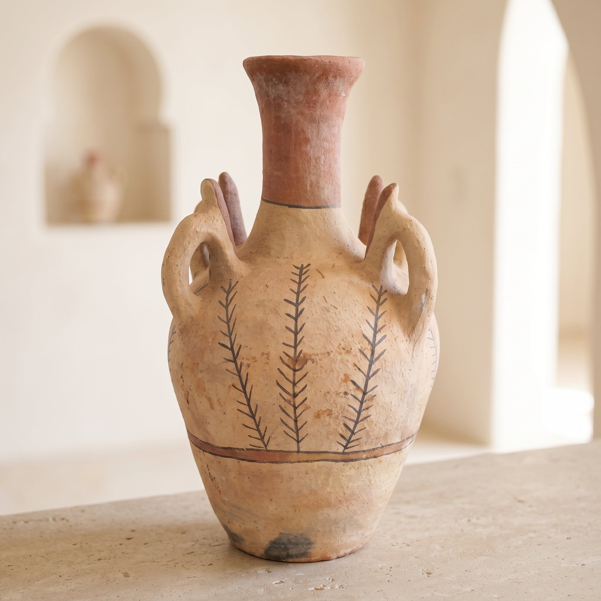 Full view of the handmade ceramic vase in a softly lit interior