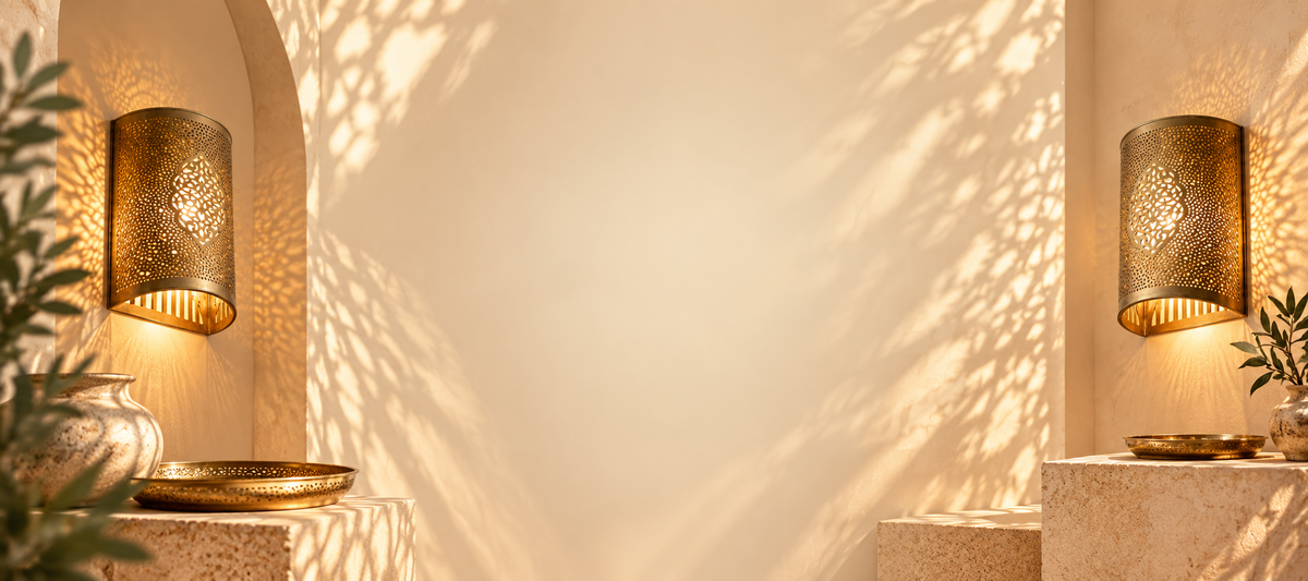 Two glowing brass wall sconces casting patterned light in a sunlit beige interior