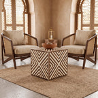 Brown and cream chevron-inlay cube side table with a tea set between armchairs