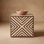 Brown and cream chevron cube side table topped with a shallow bowl