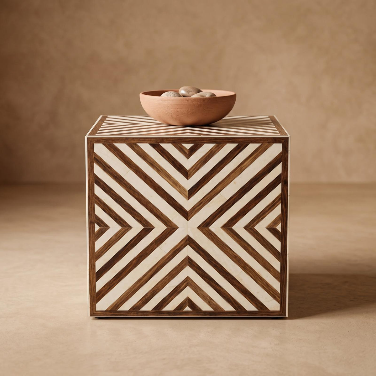 Brown and cream chevron cube side table topped with a shallow bowl