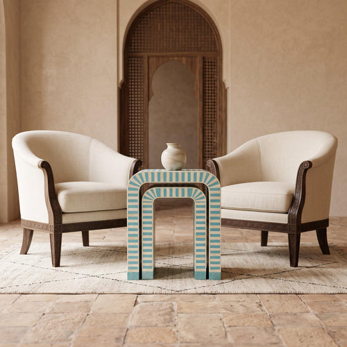 Turquoise and cream striped arch side table between two cream upholstered chairs