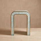 Turquoise and cream arch side table with an open rounded doorway-shaped center