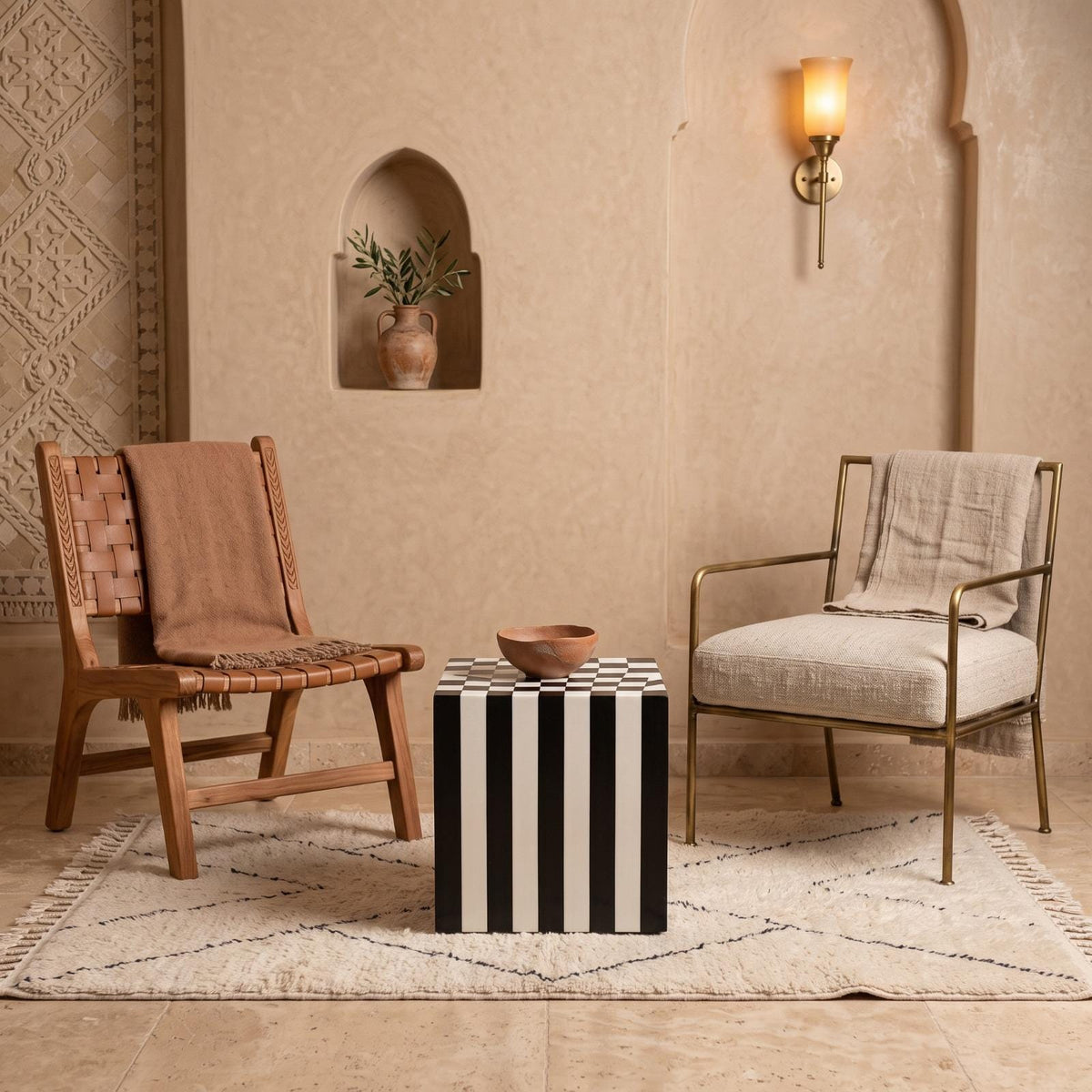 Black and white striped cube table between a woven wooden chair and a cushioned chair