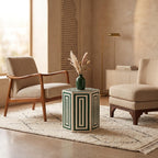 Green and cream geometric hexagonal side table topped with a vase between lounge chairs