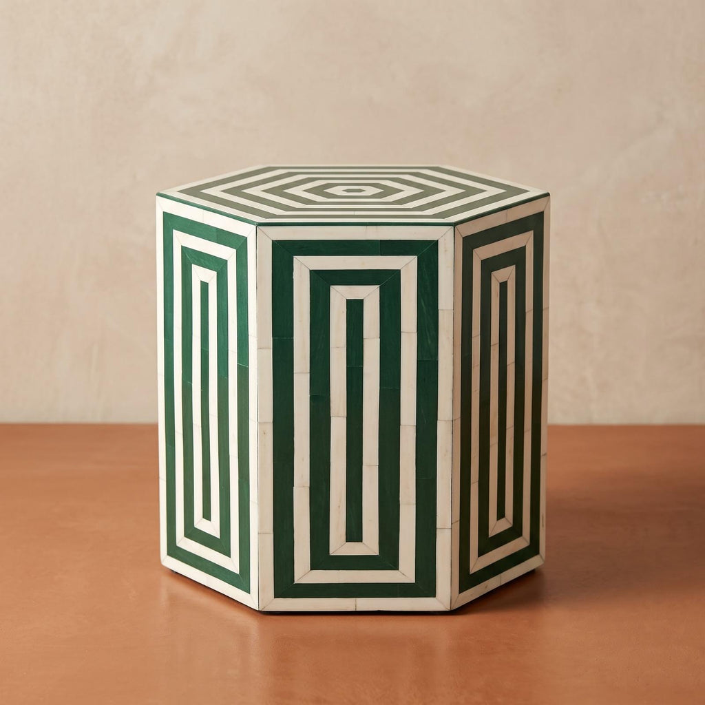 Angled view of a green and cream hexagonal side table with nested rectangular patterns