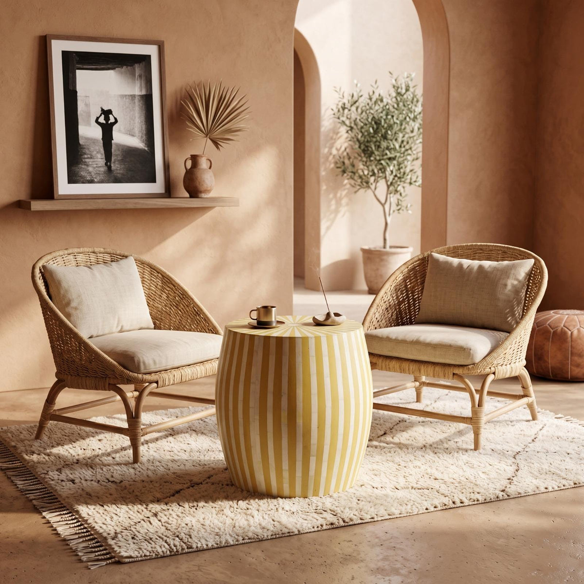 Yellow striped wooden side table between cushioned lounge chairs beneath an arched niche