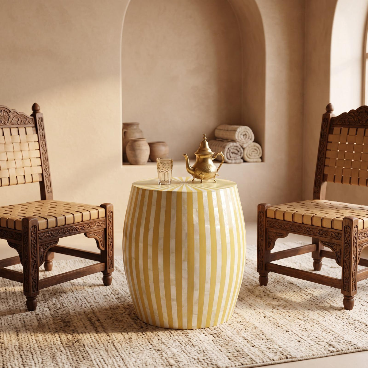 Yellow striped drum table topped with small ornaments between two woven wooden chairs