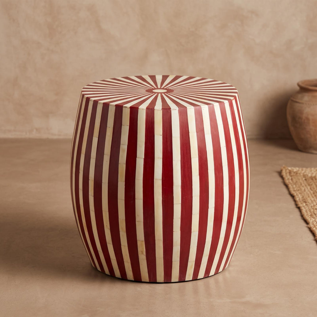 Red and cream striped drum side table showing its radial sunburst top