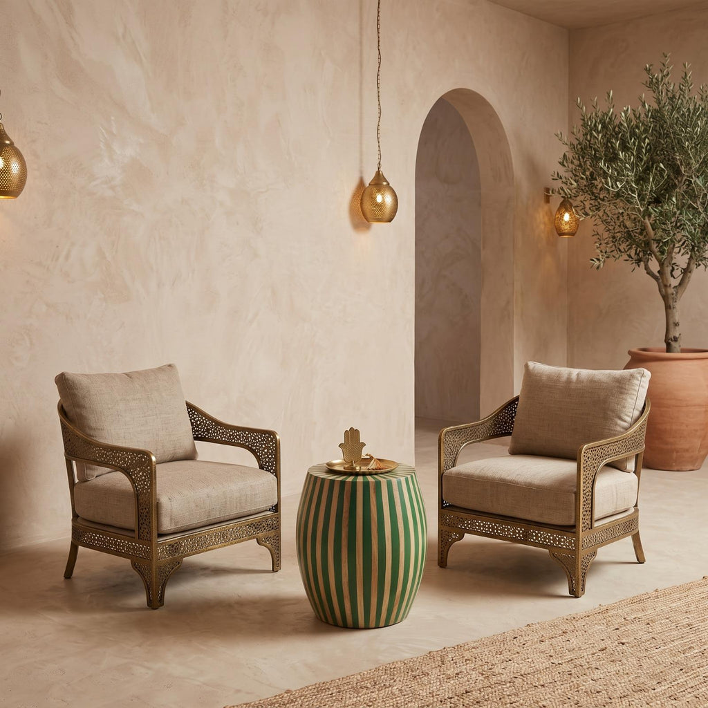 Green striped drum side table between armchairs in a beige room with an arched doorway