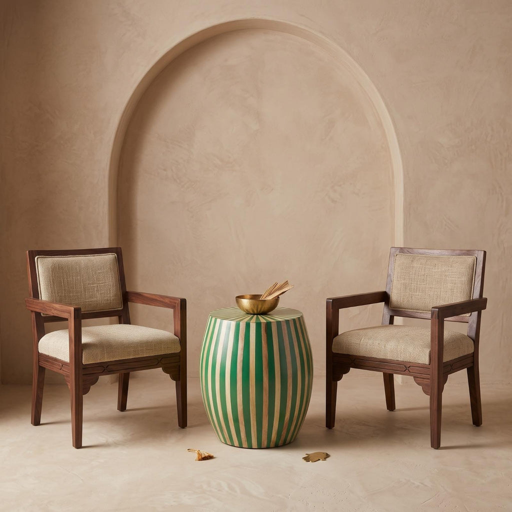 Green striped wooden side table with a sunburst top between two woven wooden chairs