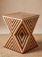 Wooden hourglass side table with contrasting chevron inlay and a diamond motif