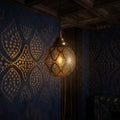 Rounded brass globe with repeating diamond-shaped panels filled with dotted perforations.