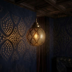 Rounded brass globe with repeating diamond-shaped panels filled with dotted perforations.