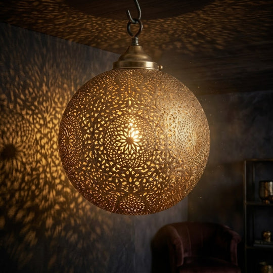 Brass globe with elaborate floral medallions, arabesque details and pierced openwork.