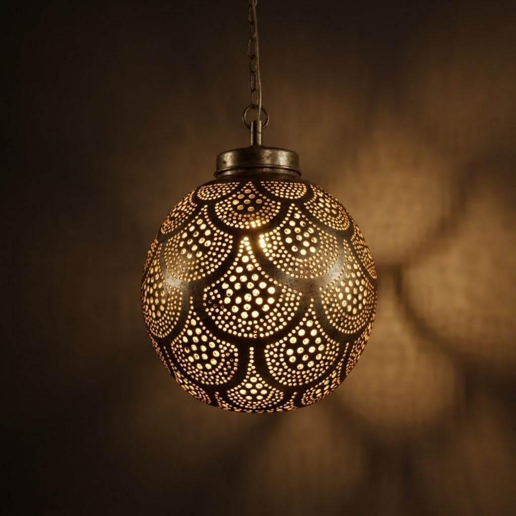 Rounded brass globe with repeating scallop outlines filled with graduated circular perforations.