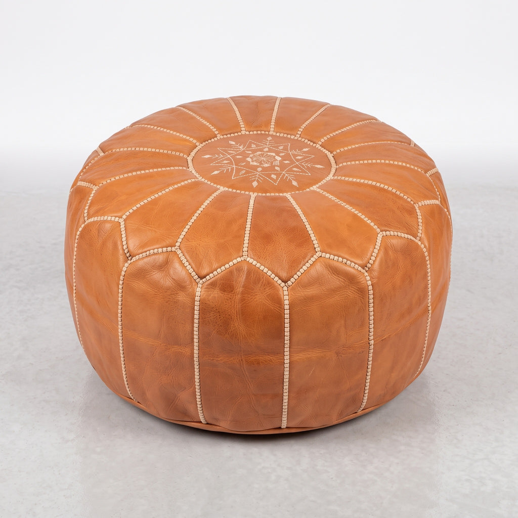 Handmade Moroccan leather pouf in caramel tan with traditional stitching