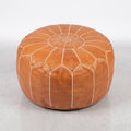 Handmade Moroccan leather pouf in caramel tan with traditional stitching