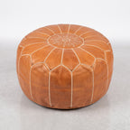 Handmade Moroccan leather pouf in caramel tan with traditional stitching