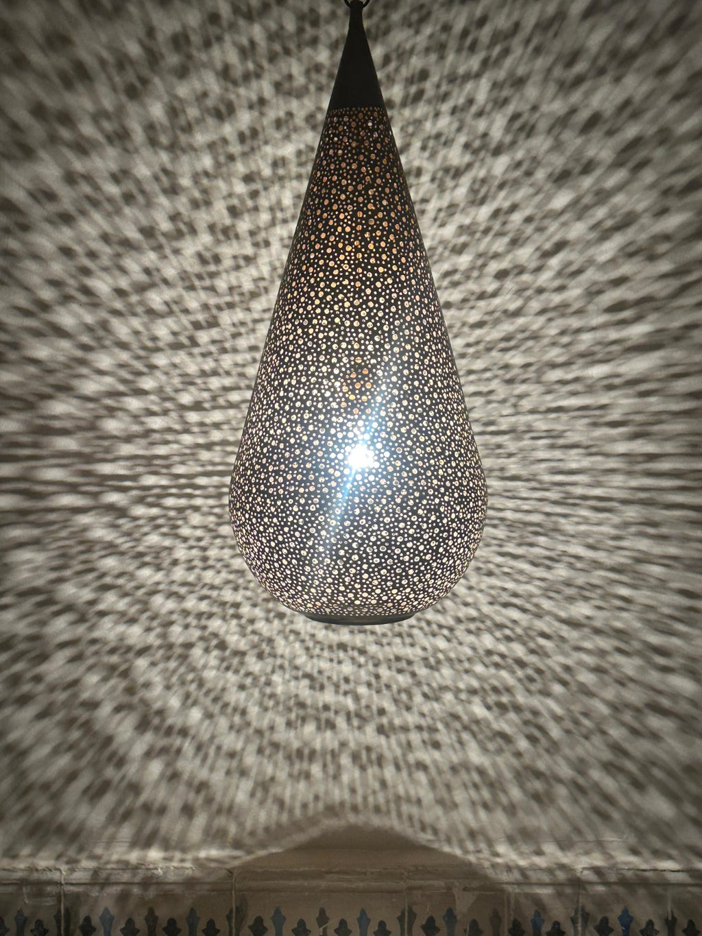 NEOMEDINA Moroccan perforated teardrop pendant casting decorative shadows