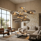Silver petal pendant above a coffee table in a stone-walled living room