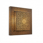Side angle of a square brass wall light showing its raised pierced rosette panel