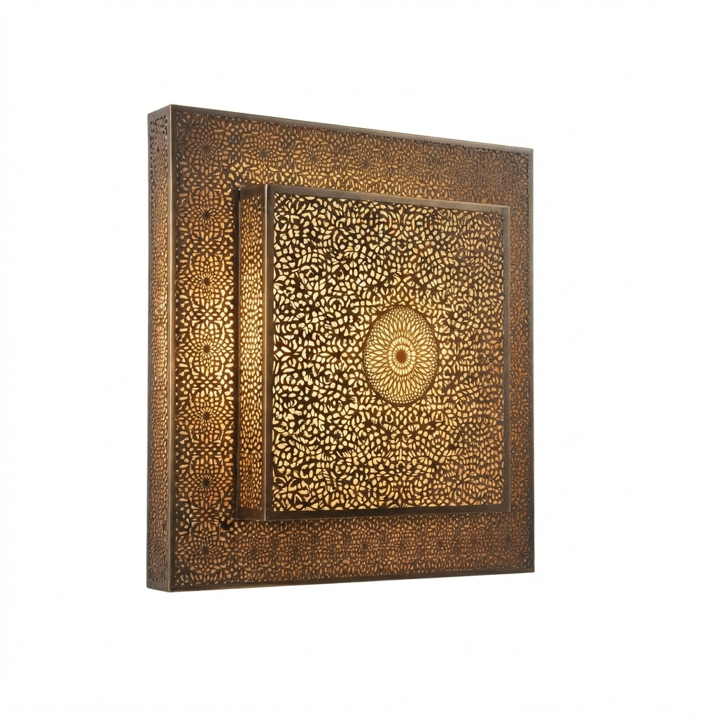 Side angle of a square brass wall light showing its raised pierced rosette panel