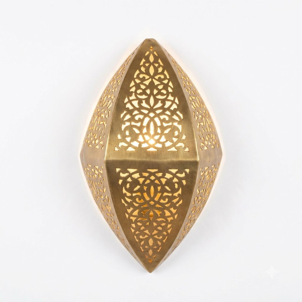 Front view of a faceted teardrop brass wall sconce with pierced floral panels