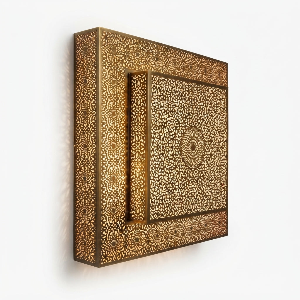 Angled view of a square brass wall light with a raised central floral rosette panel