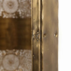 Close-up of the seam and smooth central band on a twin rosette brass wall sconce