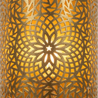 Close-up of a Moroccan brass wall sconce with pierced floral rosette and geometric patterns