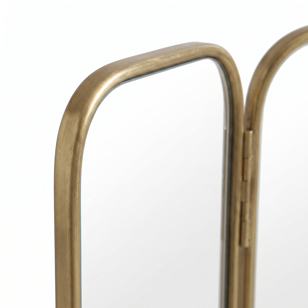 Detail of the brass frames between the central and folding side panels of the Moroccan triptych mirror