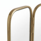 Detail of the brass frames between the central and folding side panels of the Moroccan triptych mirror