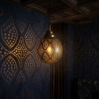 Diamond Lattice brass globe pendant projecting diamond patterns in a dark room