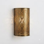 Front view of a curved brass wall sconce with pierced teardrop motifs
