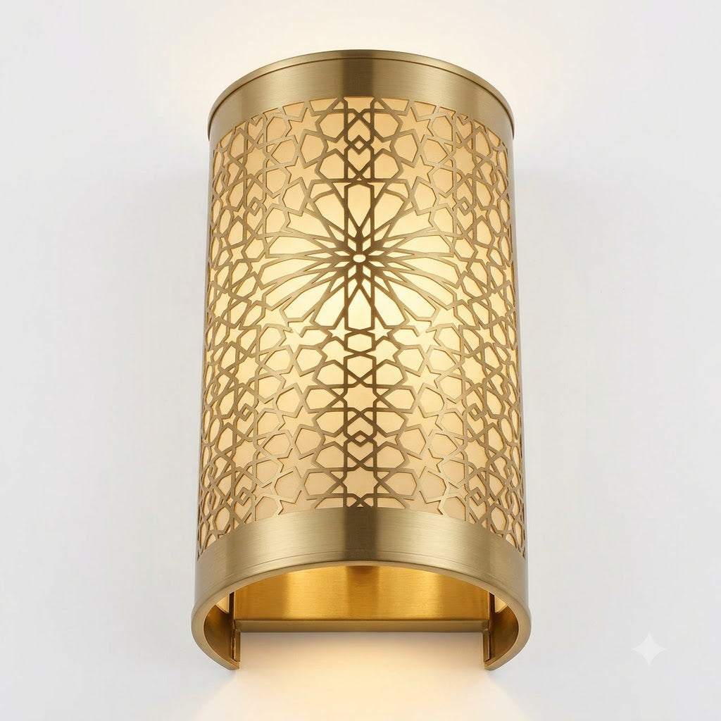 Angled view of an illuminated brass rosette wall sconce showing its open lower edge