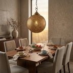Floral Medallions brass globe pendant above a set dining table