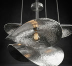 Silver hammered petal pendant with overlapping curved shades and a glowing bulb