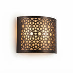 Wide curved dark brass wall sconce with an illuminated star lattice