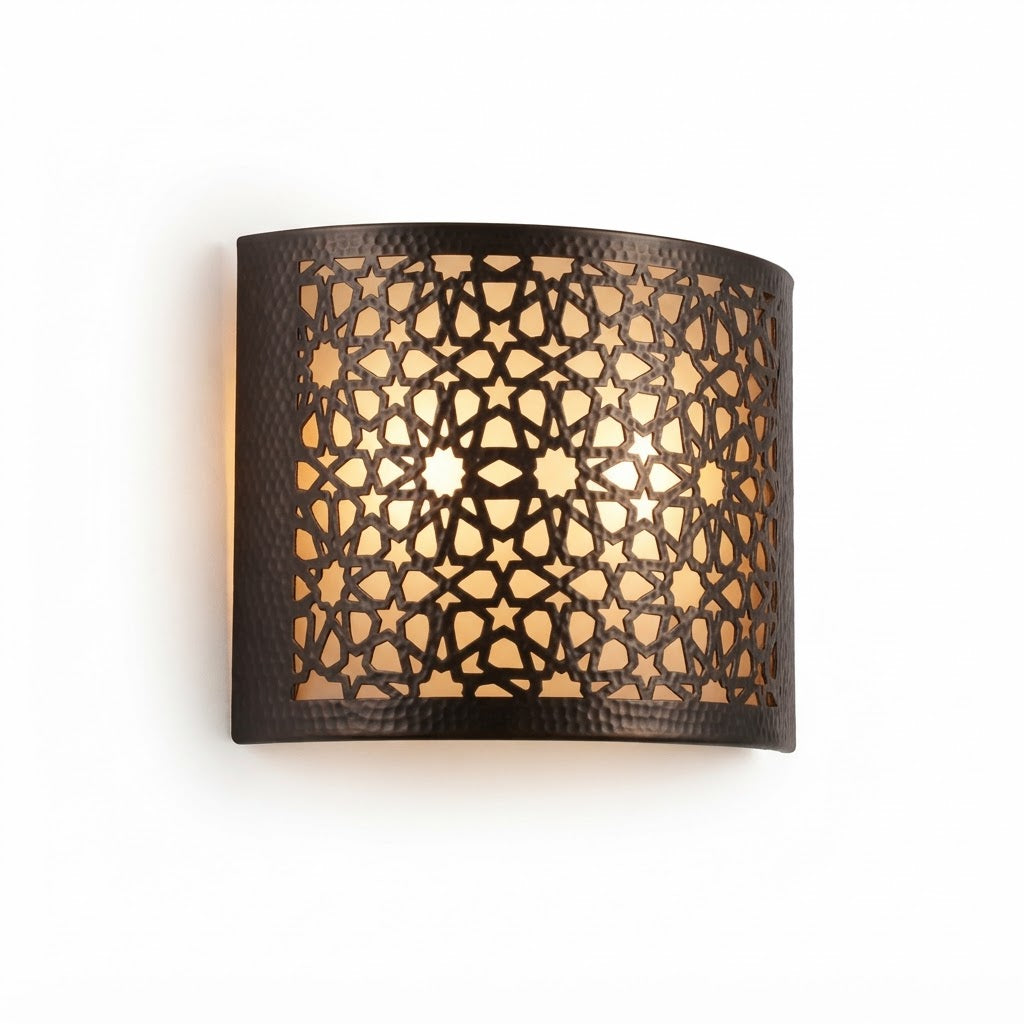 Wide curved dark brass wall sconce with an illuminated star lattice