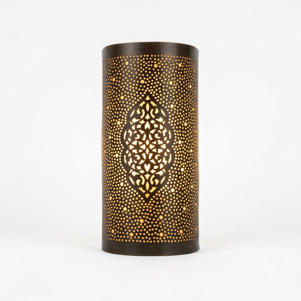 Front view of a dark curved brass wall sconce with a central arabesque medallion